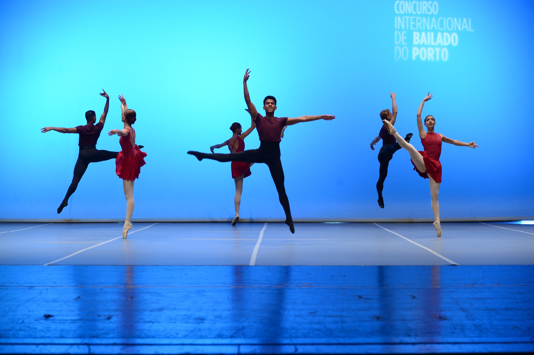 Jovens da Serra do Amolar fazem aula de dança em sala com paredes azuis.